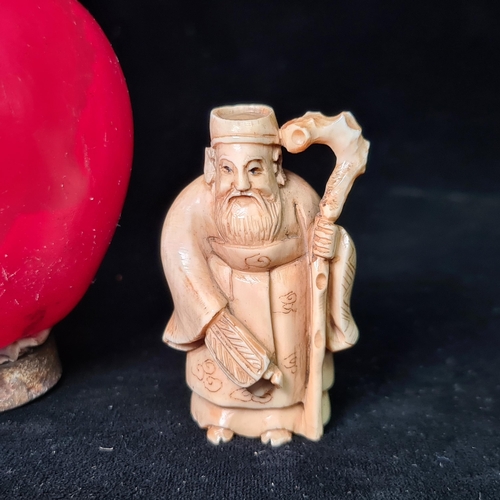 588 - An excellent example of a hand carved Japanese netsuke in the form of an elder with walking stick. S... 