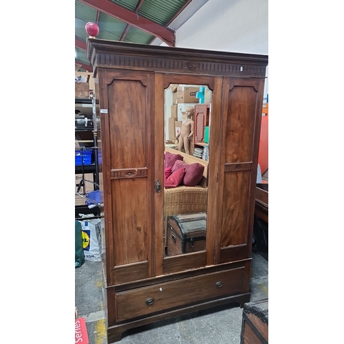 1024 - Early 20th-century mahogany wardrobe with carved details, mirrored central door, and single lower dr... 