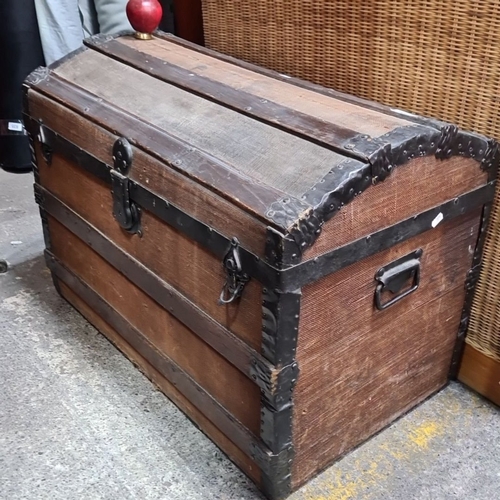 1025 - Star Lot : A Victorian wooden travel trunk with metal reinforcements and handles, featuring a curved... 