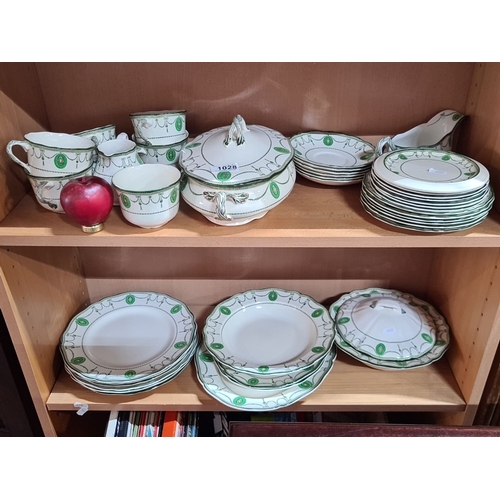 1028 - Royal Doulton Countess dinnerware set features a green and white pattern. Includes plates, cups, sau... 