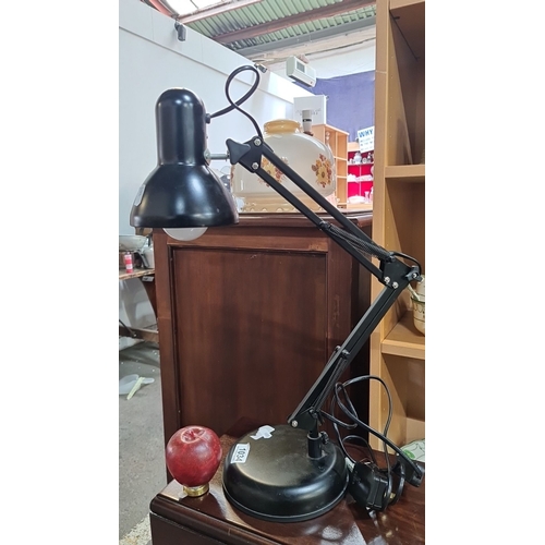 1034 - Adjustable black desk lamp with a weighted base and an articulated arm. It has a single bulb design ... 