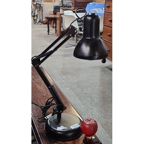 1034 - Adjustable black desk lamp with a weighted base and an articulated arm. It has a single bulb design ... 