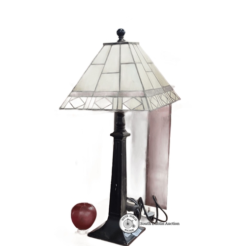 1035 - An Art Deco-inspired table lamp featuring a stained glass shade with geometric pattern and black met... 