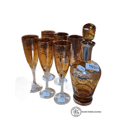 1037 - Amber glass decanter with stopper and six matching goblets, featuring intricate gold floral designs.