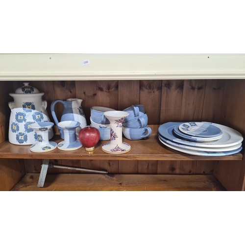 1044 - A pottery set by Suzanne May, featuring hand-painted blue floral and stripe designs. Includes plates... 