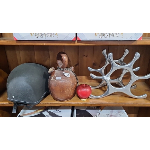 1047 - Mixed lot containing a Champion Junior Plus Jockey Helmet, leather jug with chain and a polished met... 