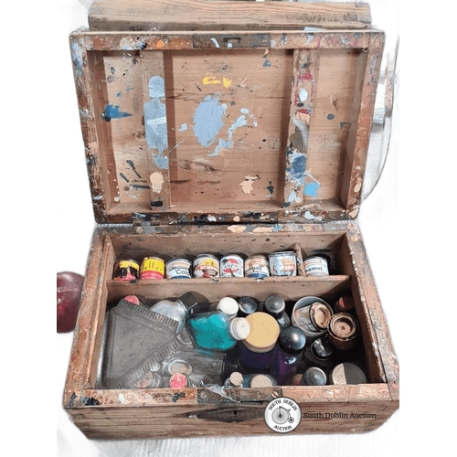 1057 - A vintage wooden artist's paint box with assorted vintage paint bottles and tools, including enamel ... 