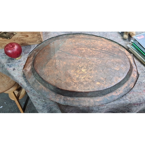 1059 - A Vintage hand-hammered copper tray with rolled-edge handles, showcasing a rustic textured finish.