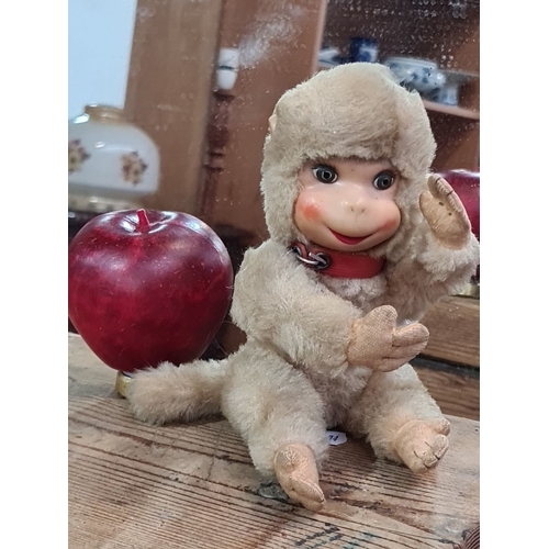 1061 - A Vintage schuco plush monkey toy featuring realistic facial features and articulated limbs. It has ... 