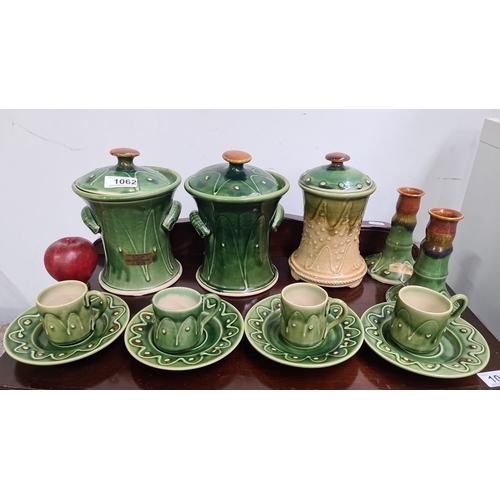 1062 - A lovely selection of castle arch pottery Including lidded jars, candlestick holders, cups, and sauc... 