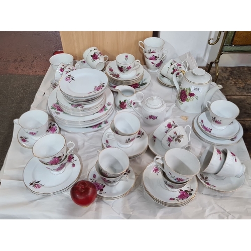 968 - A large Porcelain tea service set features a floral rose design with gold trim, made in China. The s... 