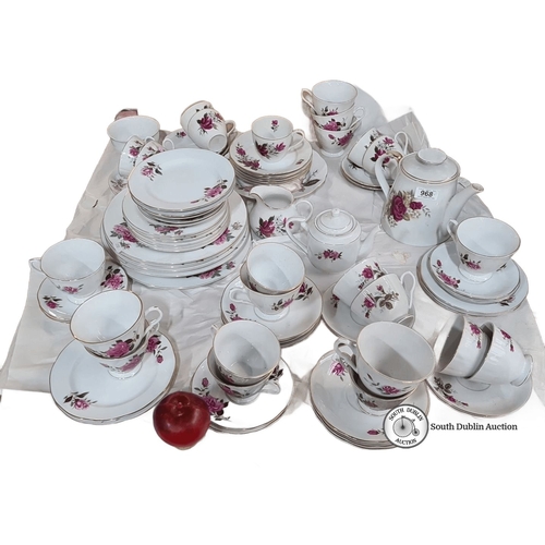 968 - A large Porcelain tea service set features a floral rose design with gold trim, made in China. The s... 