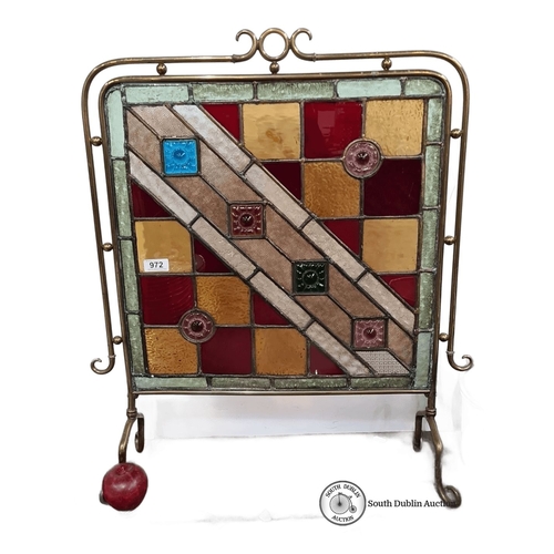 972 - Star lot :A Brass-framed stained glass fire screen, featuring a geometric pattern with squares and f... 