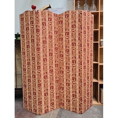 979 - Star lot : A Vintage folding room divider with red and cream patterned textile featuring stylized an... 