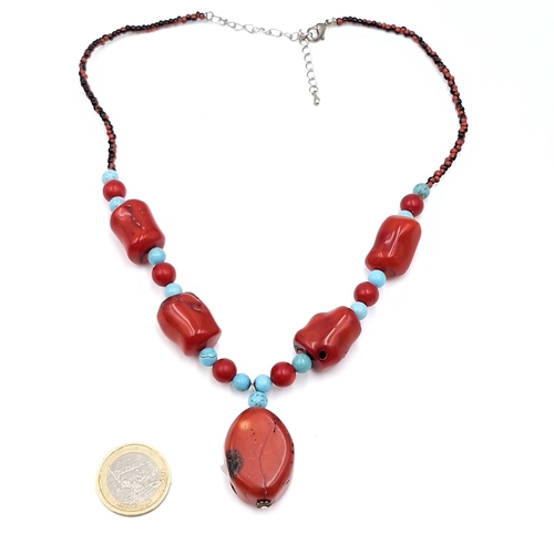 1012 - A vibrant red coral and turquoise beaded necklace. Length 52cm. Stones cold to the touch.