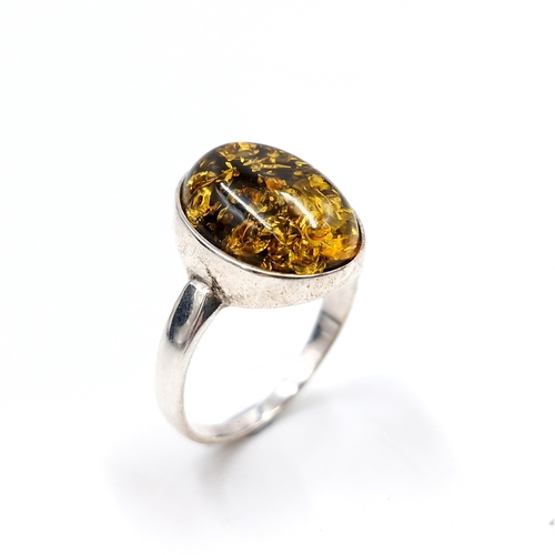 1018 - A very pretty sterling silver amber stone ring. Stamped 925 - slightly rubbed. Ring size U. Weight 3... 