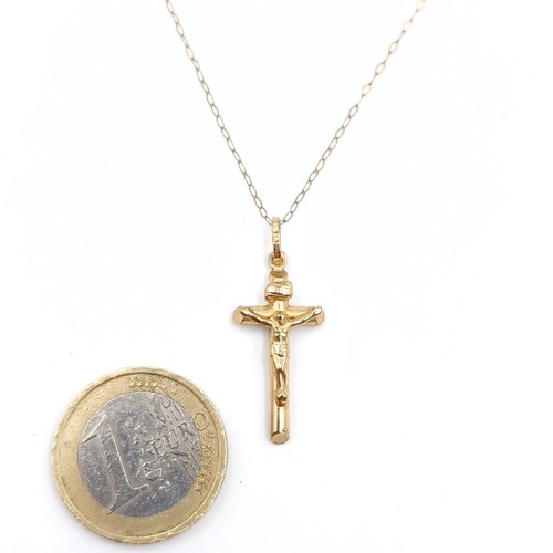 996 - A dainty nine carat gold necklace with crucifix pendant. Both stamped 375 / 9ct. Weight 1.18 grams. ... 