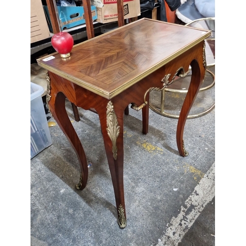 1117 - Star Lot : A very handsome French Louis XV-style wooden table with brass inlay and ornate detailing.... 