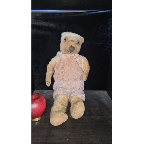 1151 - Vintage teddy bear with jointed limbs, glass eyes, hand-stitched nose, and mouth. Dressed in a handm... 