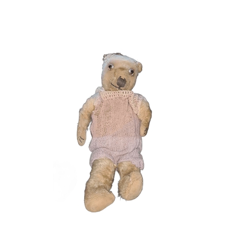 1151 - Vintage teddy bear with jointed limbs, glass eyes, hand-stitched nose, and mouth. Dressed in a handm... 