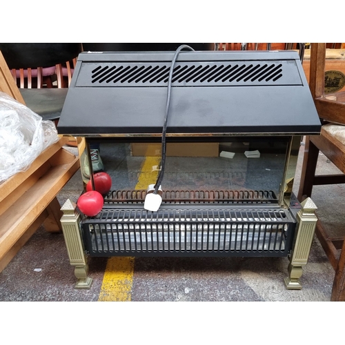 1159 - Dimplex electric fireplace heater with brass accents and plug, Model No. 73000.

Previous in auction... 