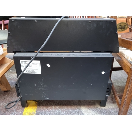 1159 - Dimplex electric fireplace heater with brass accents and plug, Model No. 73000.

Previous in auction... 