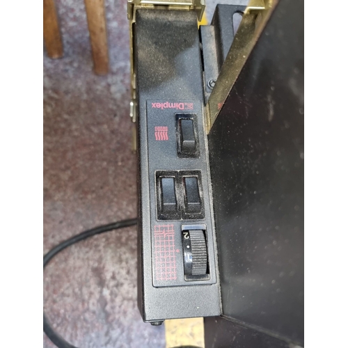 1159 - Dimplex electric fireplace heater with brass accents and plug, Model No. 73000.

Previous in auction... 