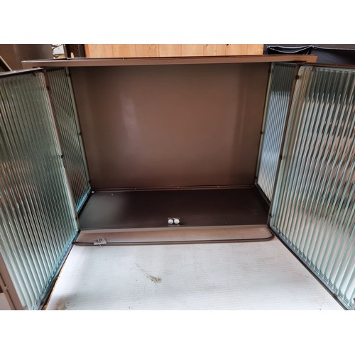 290 - A  steal cabinet featuring reeded glass panels and double doors to front. Brand new from a top Uk de... 