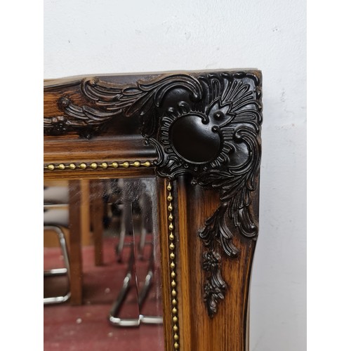 255 - Star Lot: A stunning large baroque bevelled wall mirror boasting exquisite ornate detail to each cor... 