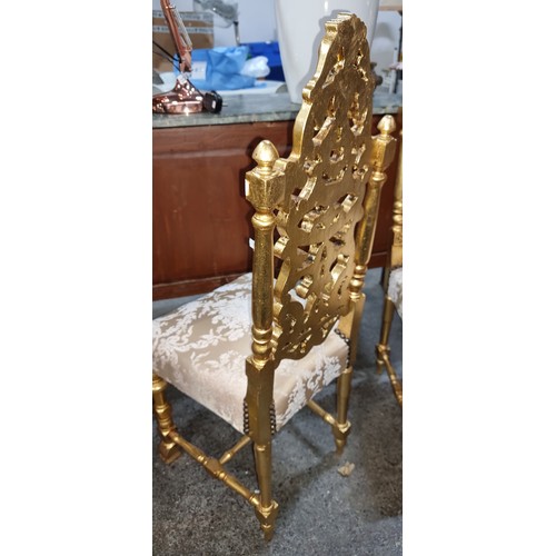 374 - Star Lot : A pair of Gilt French style hall chairs with heavily gilded and decorative carved timber ... 