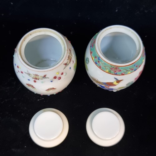 531 - A lovely pair of miniature Chinese hand painted famille rose porcelain lidded jars. Both stamped to ... 