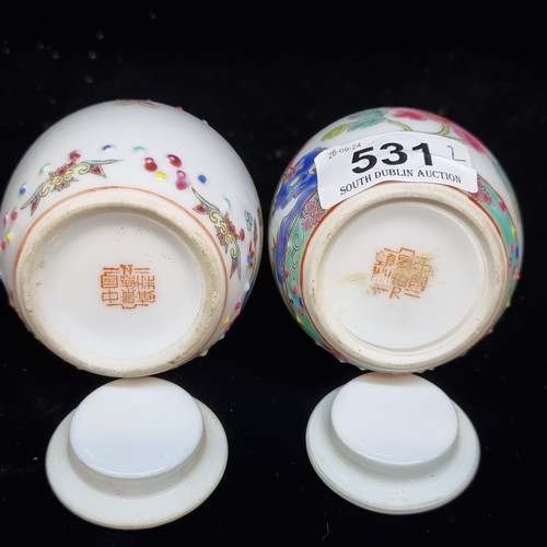 531 - A lovely pair of miniature Chinese hand painted famille rose porcelain lidded jars. Both stamped to ... 