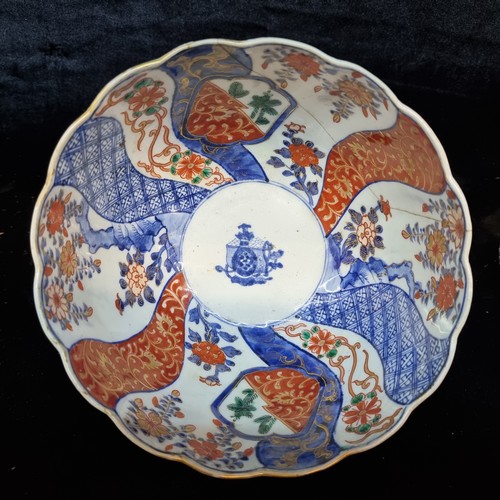 568 - An antique Japanese porcelain Imari bowl with ribbed body and scalloped edging. Wonderfully hand pai... 