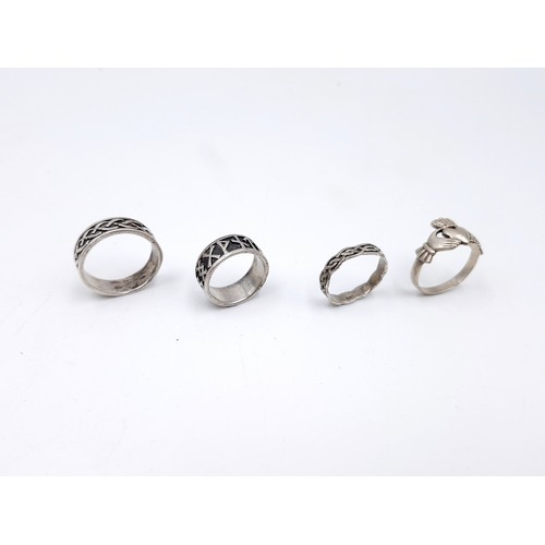 987 - Four Irish sterling silver rings including three Celtic examples and one Claddagh example. Ring size... 