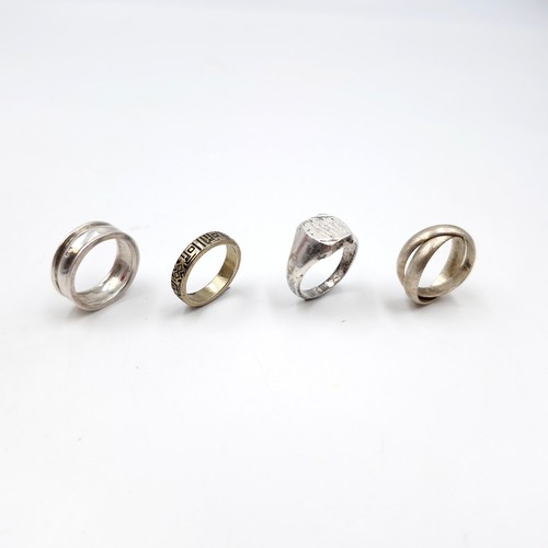 991 - Four mens silver rings with two hallmarked examples. Ring sizes N, T, P & O. Total weight 22.60 gram... 