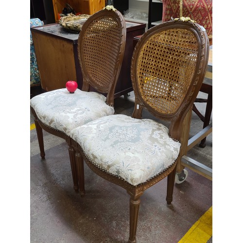 344 - Star lot : A pair of French antique style occasional chairs featuring rattan cane back supports with... 