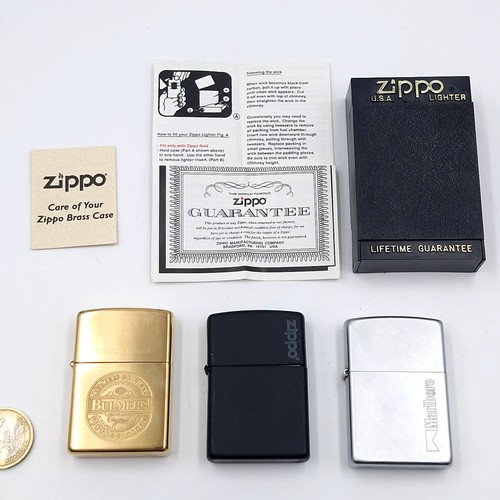 1002 - Three Zippo lighters including a Marlboro example and a Bulmer's solid brass example.