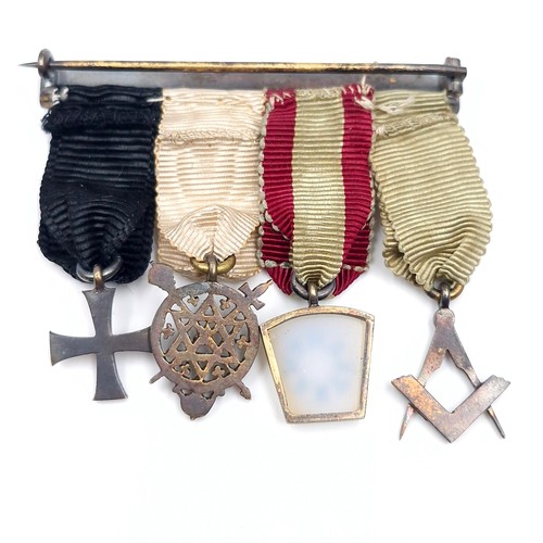 418 - An antique masonic group of dress medals mounted on a sterling silver pin holder set with shamrock m... 