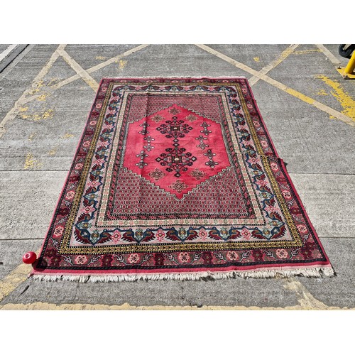 904 - Star Lot : A superb example of a hand knotted Persian style rug in vibrant tones of pinks, blues, ye...