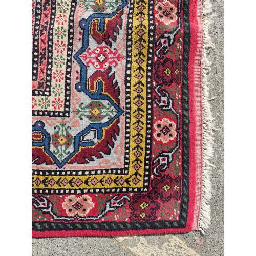 904 - Star Lot : A superb example of a hand knotted Persian style rug in vibrant tones of pinks, blues, ye... 