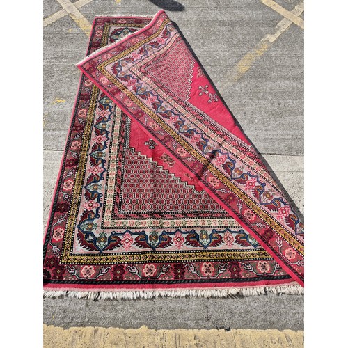 904 - Star Lot : A superb example of a hand knotted Persian style rug in vibrant tones of pinks, blues, ye... 