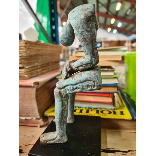 124 - Star lot : A fabulous heavy cast bronze sculpture of a stylized figure, suspended in a slumped seate... 