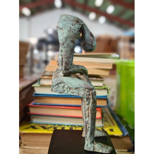 124 - Star lot : A fabulous heavy cast bronze sculpture of a stylized figure, suspended in a slumped seate... 