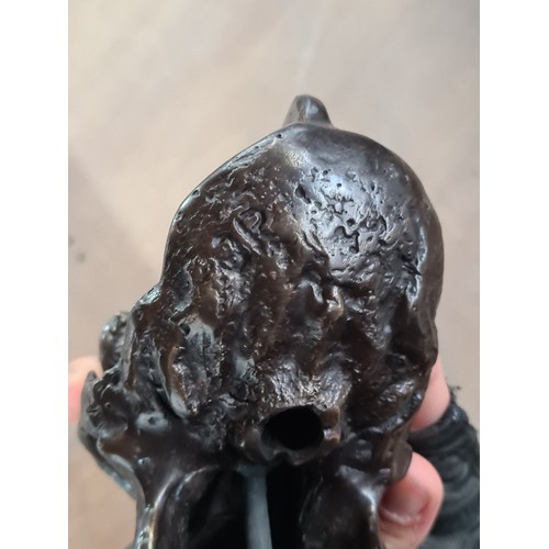 138 - Star Lot : An eye catching cast bronze sculpture in the form of a gorilla skull on a black base.