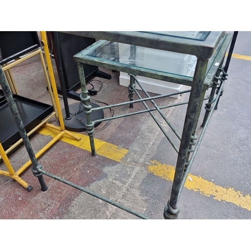 409 - Two Glass top and wrought iron tables. Including a dining table and side table. Featuring decorative... 