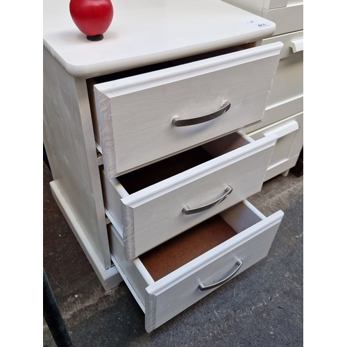 411 - White wooden bedside set of drawers, featuring brushed metal handles. Dimensions: 47 cm W x 70 cm H ... 