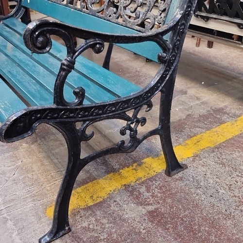 414 - Star Lot : A beautiful cast iron and wood garden bench with ornate scrollwork, measuring approximate... 