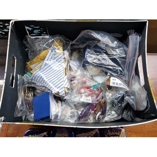 429 - A large box containing a large mixed lot of costume jewellery, unchecked and 8 empty Pokemon boxes.