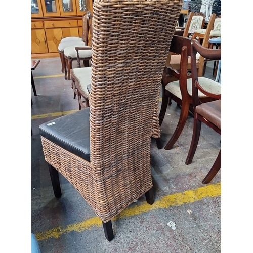 435 - Pair of wicker chairs with high backs and black leather cushions. Dimensions: 100 cm high, 40 cm sea... 