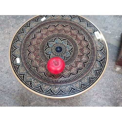 447 - A very pretty hand-painted wooden pedestal table with intricate mandala design in red, blue, and gol... 